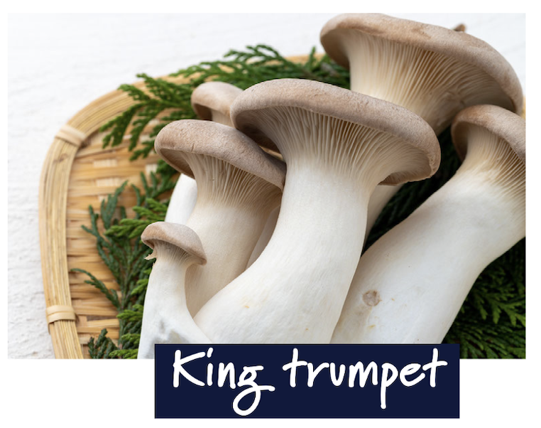 King trumpet mushrooms neatly arranged on a wooden chopping board, showcasing their thick, meaty stems and white caps.